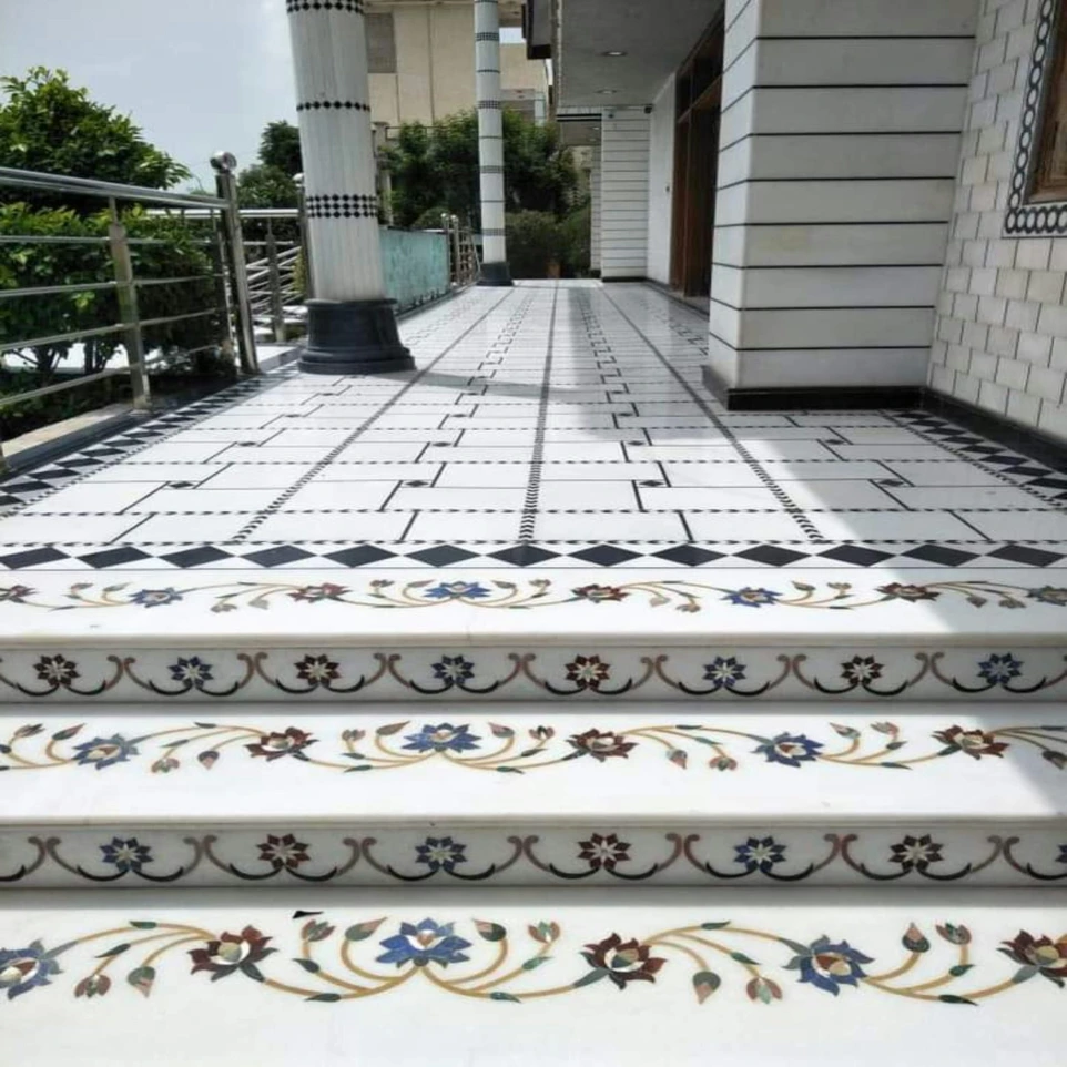 A set of white stairs with blue and gold designs